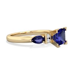 a yellow gold ring with two blue sapphires and diamonds on the sides, set in 18k yellow gold