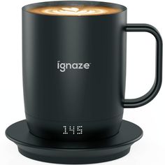 a black coffee mug with the word ignze on it sitting on top of a coaster