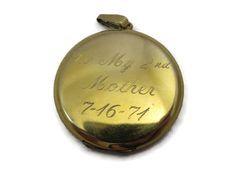 "A lovely vintage gold locket. It's 12kt gold fill, and has etched flowers and flourishes on the front. Inside there two spots for photos. On the back, it reads \"To My 2nd Mother 7-16-71\". Marked \"1/20 12kt GF\". Measures about 1.5\" across and has minor wear appropriate for age (some small scratches). The photo frame inside is bent. I am always happy to answer any questions or send more photos when needed. Thanks for shopping Vintage In Bloom! www.facebook.com/vintageinbloom More pendants &a Vintage Yellow Gold Memorial Locket Necklace, Vintage Yellow Gold Locket Necklace For Memorial, Antique Engraved Jewelry For Mother's Day, Antique 14k Stamped Locket Necklace For Anniversary, Antique 14k Stamped Locket Necklace Collectible, Vintage Stamped 14k Locket Necklace For Wedding, Vintage 14k Stamped Locket Necklace For Wedding, Victorian Engraved Locket Necklace For Memorials, Memorial Medallion Locket Necklace For Mother's Day