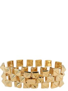 Studded bracelet in gold metal. Composition: Adjustable Gold Bracelets With Gold-tone Hardware, Luxury Yellow Gold Metal Cuff Bracelet, Modern Adjustable Bracelets With Gold-tone Hardware, Gold-tone Bangle Bracelets For Formal Occasions, Formal Gold-tone Metal Bracelets, Gold-tone Bangle Bracelet For Formal Occasions, Formal Gold-tone Metal Bracelet, Designer Gold Bracelets With Gold-tone Hardware, Modern Adjustable Jewelry With Gold-tone Hardware