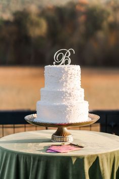 a white wedding cake sitting on top of a table