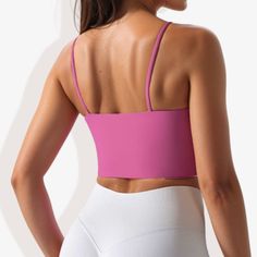 The Anna-Kaci Women's Scoop Neck Stretchy Cropped Sports Bra is a perfect blend of comfort and functionality for your athletic wardrobe. This sports bra features a scoop neckline and a cropped design, providing a modern and stylish look. Made with double-layering and 4-way stretch fabric, it ensures excellent support and flexibility during workouts. The padded cups offer additional comfort and support, making it ideal for various physical activities. Whether you're hitting the gym, going for a r Solid Sports Bra For Light Sports, Pink Seamless Tank Top For Gym, Pink Crop Top With Built-in Bra And High Stretch, Pink High Stretch Crop Top With Built-in Bra, Pink Seamless Tank Top For Pilates, High Stretch Pink Crop Top For Workout, Pink Seamless Activewear For Pilates, Sporty High Stretch Pink Crop Top, Pink Stretch Crop Top For Sports