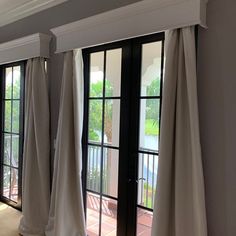 the curtains are hanging in front of the sliding glass doors