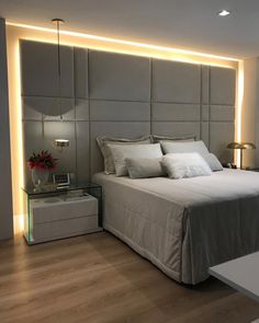 an instagram photo of a bed in a bedroom with lights on the headboard