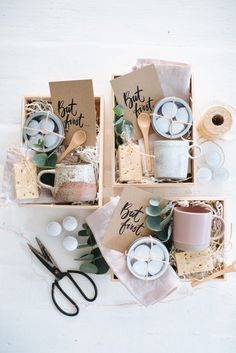 three boxes filled with different types of crafting items on top of a white table