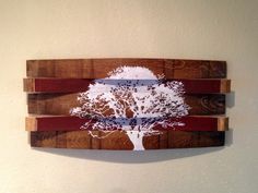 a wooden wall hanging with a tree painted on it