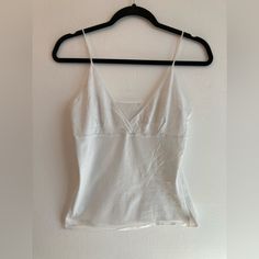 Exactly That. A White Camisole Top With No Tags Or Size. It’s Adorable! Never Worn. I’d Guess It’s A Size Medium From The Gap Lingerie Section. Fitted Tank Strap Tops For Daywear, Fitted Tops With Tank Straps For Daywear, Fitted Casual Camisole For Daywear, Seamless Cami Top For Daywear, V-neck Stretch Tank Top For Daywear, Stretch V-neck Tank Top For Daywear, Summer V-neck Bra Friendly Tops, Bra Friendly V-neck Tops For Summer, Bra Friendly V-neck Summer Tops