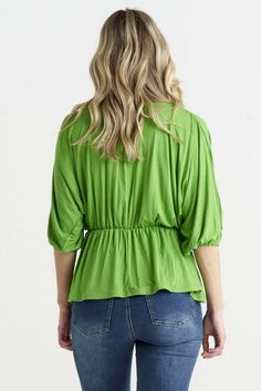 Wrap yourself in elegance with the Bayeaux Wrap Top in Artichoke. This top features a cross-over wrap at the front, creating a flattering and feminine silhouette. The V-neck adds a touch of sophistication, while the elastic cuffs on the 3/4 sleeves provide comfort and style. Made with a soft and liquid jersey fabric, this top is not only pleasing to the touch but also drapes beautifully on the body. The flattering fit with an elasticated waistline adds a chic and tailored touch. Whether you're dressing it up with a skirt for a formal occasion or pairing it with jeans for a more casual look, the Bayeaux Wrap Top in Black is a versatile and sophisticated choice that will make you feel confident and stylish. Long Sleeve Summer Dress, Maxi Dress Winter, Linen Loungewear, Sleeveless Dress Summer, Feminine Silhouette, Swimwear Sale, Skirted Swimwear, Linen Dresses, Wrap Top