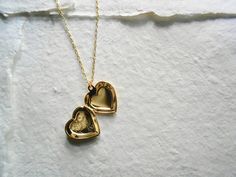 "A golden heart locket hangs from a gold chain. Please select a length from the drop-down box. The locket measures 1\" x 3/4\". *We do not personalize nor insert pictures. The locket and chain are gold plated over brass, so it's recommended removing before showering, swimming, etc. to keep jewelry looking like new." Heart Charm Pendant Locket Necklace As Keepsake, Heart Charm Locket Necklace As Keepsake, Heart Charm Locket Necklace For Keepsake, Keepsake Heart Charm Locket Necklace With Round Pendant, Keepsake Pendant Locket Necklace With Heart Charm, Keepsake Locket Necklace With Heart Charm, Keepsake Heart Charm Locket Necklace, Heart Charm Medallion Locket Necklace Keepsake, Keepsake Medallion Locket Necklace With Heart Charm