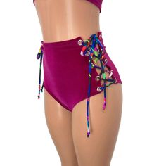 Our classic high waist hot pants with scrunch ruching detail in back to offer a "cheekier" look AND Lace-up sides! These hot pants are made of stretchy fuchsia velvet with splatter print ties and sit high on your natural waist. The lace-up sides make these more adjustable to fit you even better. Wear as a bikini bathing suit bottom, panties, rave shorts, etc. They have a built in liner and are made to be flattering to your figure. Trendy High Waist Swimwear With Built-in Shorts, Trendy High-waist Swimwear With Built-in Shorts, Summer Swimming Bottoms With Ruched Sides, Trendy Stretch High-waisted Swim Shorts, Beachwear Bottoms With Ruched Tie-sides, Summer Pool Bottoms With Ruched Sides, Purple Fitted High Waist Swimwear, Fitted High Waist Purple Swimwear, Purple Fitted High-waist Swimwear