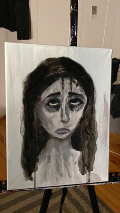 a drawing of a woman's face on a canvas