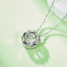 An eye-catching round moissanite dances with ease at the center of this appealing women's necklace, expressing your unstoppable love. Additional round gem set in sterling silver frame the center. Features Moissanite was originally found in meteorites(Chemical name: Silicon Carbide). It was first discovered in 1893, while a scientist was examining meteor samples from a crater in Arizona. After many years, the experts has been recreated moissanite in the laboratory, that make the gemstone with fri White Gold Necklace With Center Round Stone, White Gold Necklace With Center Stone, Moissanite Necklace With Center Stone In Round Cut, Moissanite Necklace With Center Stone As Gift, Sterling Silver Solitaire Necklace With Halo Design, Anniversary Necklace With Round Center Stone, Silver Solitaire Necklace With Brilliant Cut Round Shape, Silver Solitaire Necklace With Brilliant Cut Round Stone, Silver Solitaire Necklace With Brilliant Cut