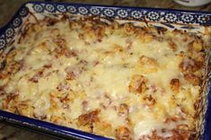 a casserole dish filled with cheese and meat