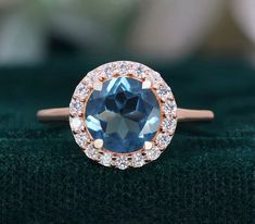 If you would prefer a custom ring, please contact us. PRODUCT DETAILS: Sku Number RG8980 8.00 mm Round London Blue Topaz Gemstone  Accents: Moissanite Plating - 14k Rose gold  TYPES OF PLATING, VERMEIL & THEIR BENEFITS: 1) Rhodium Plating: Rhodium is a precious metal that is in the family of platinum. There are many upsides of rhodium plated jewelry. First, it increases shine, luster and durability. Additionally, it makes jewelry more resistant to scratches and less prone to tarnish. Rhodium pla Formal Rose Gold Topaz Ring With Halo Setting, Rose Gold Topaz Ring With Prong Setting, Rose Gold Sapphire Ring With Halo, Rose Gold Topaz Ring With Gemstone, Rose Gold Topaz Ring With Center Stone, Rose Gold Topaz Gemstone Ring, Rose Gold Topaz Ring For Gift, Rose Gold Topaz Ring, Topaz Ring With Halo Design