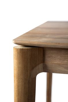 a close up of a wooden table with one leg on the other side and two legs at the top