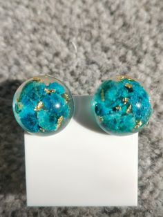 These stunning earrings are made with blue baby Breaths together with gold leaf, setting in crystal clear resin. They are 100% hand made by me🌸 Perfect Gift for Any occasion. Blue Round Plug Earrings As Gift, Blue Round Plug Earrings For Gift, Blue Resin Jewelry For Party, Blue Resin Jewelry For Parties, Blue Plug Earrings For Gifts, Handmade Blue Round Clip-on Earrings, Unique Blue Jewelry With Natural Inclusions, Gold Round Resin Earrings, Elegant Blue Resin Earrings