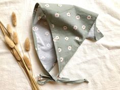 A pretty and whimsical hair kerchief in a light sage green with sweet white daisies 🌼 The dimensions are 35 inches in length (including ties), and 15.5 inches diagonally.  The fabric is cut on the bias, giving it a beautiful drape.  The bandana is a preshrunk soft 100% cotton.  Can be washed and dried by machine, for very easy care. This would be perfect for working in the garden, going on picnics, or just keeping your hair out of your face while you go about your day. All items come packed in Hair Kerchief, Whimsical Hair, Kerchief Hair, Floral Bandana, Sage Green Floral, Light Sage Green, White Daisies, White Daisy, Beautiful Drapes