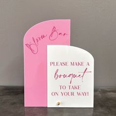 a pink and white sign with writing on it that says please make a bouquet to take on your way