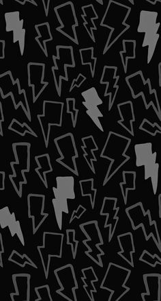 an abstract black and white pattern with lightning bolt shapes in the center, on a dark background