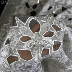 a woman's white wedding garter on display