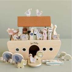 a wooden toy boat with animals and other toys