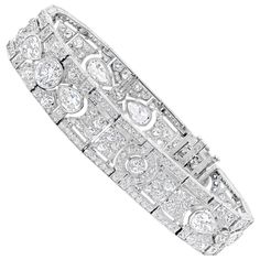 A beautiful antique bracelet, featuring an open-work art deco design with 17.00 carats total of brilliant mixed cut diamonds including round and pear shape. Finished with milgrain edges. Elegantly made with platinum, 7 inches in length. Perfect bracelet for a fancy event. Bracelet Art, Platinum Bracelet, Retro Bracelet, Expensive Jewelry Luxury, Art Deco Bracelet, Antique Bracelets, Diamond Jewelry Designs, White Gold Bracelet, Expensive Jewelry