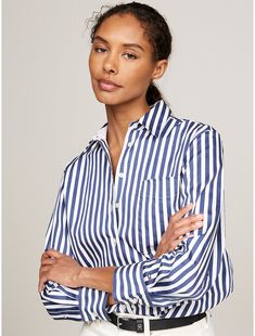 Tommy Hilfiger women's shirt. A bold stripe design makes this versatile, oversized, stretch-cotton shirt an easy choice for the office and the hours beyond.  Material: 97% Better Cotton Initiative, 3% Elastane. Chic Striped Shirt For Daywear, Casual Workwear Top With Horizontal Stripes, Chic Vertical Stripes Office Shirt, Chic Office Shirt With Vertical Stripes, Striped Cotton Shirt For Work, Office Cotton Shirt With Vertical Stripes, Relaxed Fit Contrast Stripe Workwear Tops, Casual Shirt With Vertical Stripes For Office, Relaxed Fit Striped Collared Blouse