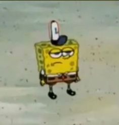 the spongebob is standing in the snow with his hat on and eyes closed