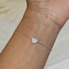 Our Dainty Silver Heart Bracelet features a delicate heart charm encrusted with CZ crystals.  This minimalist bracelet makes a great statement piece and will look great worn alone or stacked with our other bracelets. We make our jewellery in small batches to reduce wastage. Our jewellery is designed with the modern Woman in mind, elegant, unique pieces with a classic touch. Our jewellery is great for gifting, whether it's Valentines, Mothers Day, Birthday or simply a gift for a friend, sister et Dainty Silver Bracelet, Jewellery Dainty, Heart Jewellery, Dainty Gold Bracelet, Silver Heart Bracelet, Bracelet Heart, Bracelet Minimalist, Minimalist Bracelet, Engraved Necklace