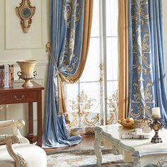 an elegant living room with blue and gold curtains