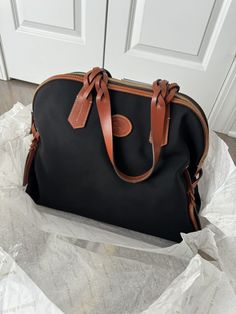 This is a stunning 2013 vintage Dooney & Bourke large dome satchel shoulder bag in black. It features a combination of leather and canvas for the exterior material, with a bag height of 10 inches and a depth of 6.25 inches. The brand name is clearly displayed on the bag and it is designed for women. The bag is perfect for all occasions and can easily be paired with any outfit. It has a timeless style and is the perfect addition to any collection. The bag is in excellent condition and comes with tags. Vintage Black Bags With Leather Trim, Classic Satchel With Leather Trim For Errands, Black Satchel With Leather Trim And Coated Canvas, Black Coated Canvas Satchel With Leather Trim, Black Shoulder Bag With Leather Trim For Daily Use, Black Shoulder Bag With Leather Trim, Black Shoulder Bag With Leather Trim For Errands, Classic Black Canvas Satchel, Black Satchel Shoulder Bag With Canvas Lining