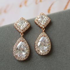 Rose gold vintage style zircon  earrings  Great for you or for your bridesmaids. Colour: rose gold /clear Stud earrings. Measurements: approx 3.5 cm, width approx  x 12mm . Materials:  rhodium over brass  components, zircon crystals. SAME STYLE in silver/blue: https://www.etsy.com/uk/listing/976619935/something-blue-wedding-earrings-for?ref=shop_home_active_1 SAME STYLE in silver/clear tone: https://www.etsy.com/uk/listing/962646758/wedding-earrings-for-brides-art-deco?ref=shop_home_active_2 Great for wedding or other celebration. MORE SAME STYLE: https://www.etsy.com/uk/shop/BridalArtDeco?ref=listing-shop-header-item-count&section_id=23918122 Please note some images have been enlarged to allow for details to be shown. Read the descriptions for details on actual size of each item. In all m Gowns Reception, Blue Earrings Wedding, Teardrop Bridal Earrings, Brass Components, 1920s Wedding, Something Blue Wedding, Wedding Bridesmaid Jewelry, Deco Earrings, Zircon Earrings