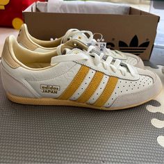 Adidas Japan Shoes Size 7.5 Women, 6 Men Colour Off White / Spark / Orange Tint (Looks More Mustard) Product Code Ig2011 Sold Out On Adidas Website; Brand New In Box Adidas Japan Shoes Outfit, Retro Mustard Low-top Sneakers, Vintage Yellow Sneakers For Streetwear, Adidas Yellow Leather Sneakers, Classic Yellow Sneakers With Round Toe, Vintage Yellow Sneakers With Gum Sole, Vintage Yellow Sneakers With Round Toe, Vintage Yellow High-top Sneakers, Classic Yellow Sneakers With Gum Sole