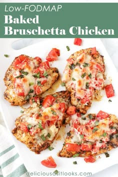 baked bruschetta chicken cut in half on a white plate with tomatoes and herbs