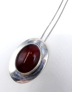 "Vintage marked Nakai sterling silver and dark red cabochon pendant necklace, In good vintage condition. The chain 17\" ½ long. Pendant 1\" 5/8 long 1\" 1/8 wide, Dark red cabochon 24 mm x 17 mm. Weighs 12.5 gram. Thanks." Formal Red Medallion-shaped Jewelry, Formal Round Pendant Necklace Stamped 925, Red Jewelry With Large Oval Pendant, Red Medallion Necklace For Formal Occasions, Formal Oval Silver Chain Necklace, Vintage Hallmarked Oval Cabochon Necklace, Antique Red Necklace With Large Pendant, Antique Red Oval Pendant Jewelry, Red Oval Hallmarked Necklace