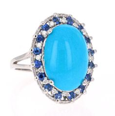 Ring Attributes: Oval Cut Turquoise = 6.48 Carats. 16 Sapphires = 0.79 Carats. 16 Round Cut Diamonds = 0.18 Carats. (Clarity and Color: VS2 - H).   Total Carat Weight = 7.45 Carats.  14K White Gold = 7.4 Grams. Ring Size = 7 (Free ring sizing available) Luxury Blue Cabochon Gemstones, Luxury Blue Turquoise Ring For Wedding, Elegant Multi-stone Turquoise Gemstones, Oval Blue Multi-stone Gemstones, Blue Oval Multi-stone Gemstones, Luxury Blue Turquoise Ring For Formal Occasions, Formal Turquoise Multi-stone Rings, Luxury Multi-stone Turquoise Round Ring, Luxury Blue Multi-stone Turquoise Ring