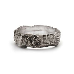 a silver ring with mountains in the middle and trees on it's sides, against a white background