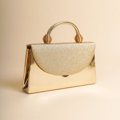 The sides and chain strap of this wedding clutch bag made of faux leather and glitter fabric are gold colored. Basic make-up supplies, cell phone, key chain, credit card and money can easily fit into this luxury mini bag. The interior of this evening bag has a single compartment and is lined with suede. It has a 120 cm removable chain strap. This wedding clutch is completely handmade. Features: Faux leather and glitter fabric. Fits basic makeup, cell phone, key chain, credit card and money. Suede lined and single compartment. 120 cm removable chain strap. The sides and chain strap are silver. It is completely handmade. Size: Width: 24 cm (9,4 inches) Lenght: 14 cm (5,5 inches) Depth: 5 cm (1.9 inches) Strap: 120 cm (47 inches) Cream, perfume, alcohol, bleach etc. Avoid contact with substan Gold Clutch Purse, Formal Bag, Gold Clutch Bag, Formal Clutch, Gold Evening Bag, Evening Accessories, Glitter Clutch, Clutch Bag Wedding, Gold Clutch