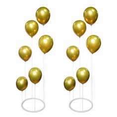 several gold balloons are floating in the air on a white stand with metal poles and round bases