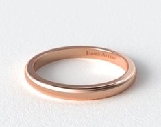 an 18k rose gold wedding ring with the name jane ann engraved on it's side