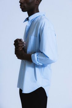 An ultra-crisp button up shirt with the effortless proportions of 90's Wall Street. Worn untucked or half-tucked, this oversized, billowy office staple makes for the ultimate off-duty move. Constructed from 100% pima cotton, a superior high-grade cotton known for it's incredible softness. Oversized Blue Button-up Shirt, Oversized Blue Shirt For The Office, Oversized Tops With Button Cuffs For Business Casual, Oversized Blue Shirt With Button Closure, Blue Relaxed Fit Shirt For Office, Oversized Blue Shirt For Work, Oversized Long Sleeve Business Shirt, Modern Oversized Shirt For Office, Oversized Button-up Shirt For Office