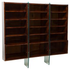 two wooden bookshelves with glass shelves on each side and one closed bookcase in the middle