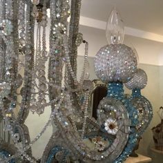 a chandelier with many beads hanging from it's sides in a room