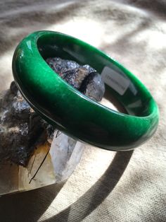 62.53 mm Swirly Green Moss Jadeite Bangle Bracelet #421 Size: 62.53 mm x 8mm x 18mm Weight: 72.61g = 363.05 Ct This is a weighty, solid piece of jade with some natural stone wen lines! Great starter bangle! Priced accordingly. Gem certificate included with purchase. Elegant Green Round Bangle, Green Classic Bangle For Formal Occasions, Classic Green Bangle Jewelry, Classic Green Gemstone Bracelets, Formal Jade Bangle Bracelet, Classic Green Bangle Bracelet, Classic Jade Bracelets For Formal Occasions, Classic Green Round Bangle, Green Jade Bracelets For Formal Occasions