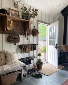 a living room filled with furniture and lots of hats hanging on the wall next to a fire place