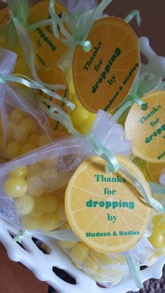 a white basket filled with oranges and candies