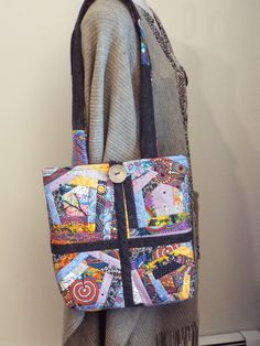 This cute bag measures 13 inches high and 12 inches wide. It is lined and with a woven cotton fabric and and it has a layer of batting hidden inside. There is a 5 1/2 by 8 inch zippered pocket on the inside.  It closes at the top with a button and loop. The front is a very colorful crazy quilt design and the back is charcoal black. My home is smoke and pet free. Thanks so much for browsing LuvLynda Any questions about this cute bag? Please don't hesitate to ask. Multicolor Fabric Bags With Pockets, Fabric Tote Shoulder Bag With Zipper, Fabric Tote Shoulder Bag With Zipper Closure, Fabric Shoulder Bag With Zipper Pocket For Travel, Fabric Shoulder Bag With Zipper Pocket For Daily Use, Daily Use Fabric Shoulder Bag With Zipper Pocket, Fabric Bags With Cell Phone Pocket For Everyday Use, Fabric Bag With Cell Phone Pocket For Everyday Use, Everyday Fabric Shoulder Bag With Patchwork