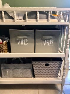 a white shelf filled with bins and baskets