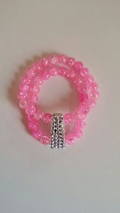 Stunning hot pink glass beads with a shattered look connected to a rhinestone focal piece. The perfect double banded stretch cord bracelet. Pink Beaded Stretch Bracelet For Party, Pink Faceted Beads Bracelets For Party, Pink Crystal Bracelet With 8mm Beads For Party, Pink Crystal Bracelet With Round Beads For Party, Adjustable Pink Crystal Bracelet With Faceted Beads, Pink Crystal Bracelet With Faceted Beads For Party, Pink Crystal Bracelets With Round Beads, Pink Crystal Beaded Bracelets With Round Beads, 8mm Crystal Bead Bracelet