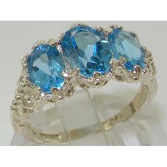 *This admirable ring is made from 925 Sterling Silver Gold with Natural Semi-precious Blue Topaz.*Total gem weight 3.4ctAn impressive Victorian / Antique Style Ring set with a center 8x6mm (0.32"x0.24" inches) & two 7x5mm (0.28"x0.20" inches) oval cut Blue Topaz in Solid 925 Sterling Silver Gold prong setting. This ring has a good solid feel, a nice weight and a good thick shank.*Total Height 5mm, Width 16mm, Length 11mm Made completely from Solid English Sterling Silver. This ring has been Three-stone Blue Topaz Ring For Anniversary, Anniversary Three-stone Blue Topaz Ring, Blue Topaz Three Stone Ring For Anniversary, Three Stone Blue Topaz Ring For Anniversary, Fine Jewelry Blue Topaz Three Stone Ring, Three Stone Topaz Anniversary Ring, Elegant Blue Topaz Three Stone Ring, Formal Blue Topaz Three Stone Ring, Elegant Three Stone Topaz Ring In Sterling Silver